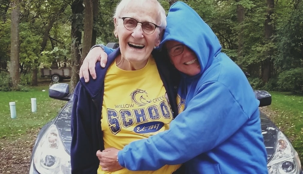 Susan sharing a warm hug outdoors