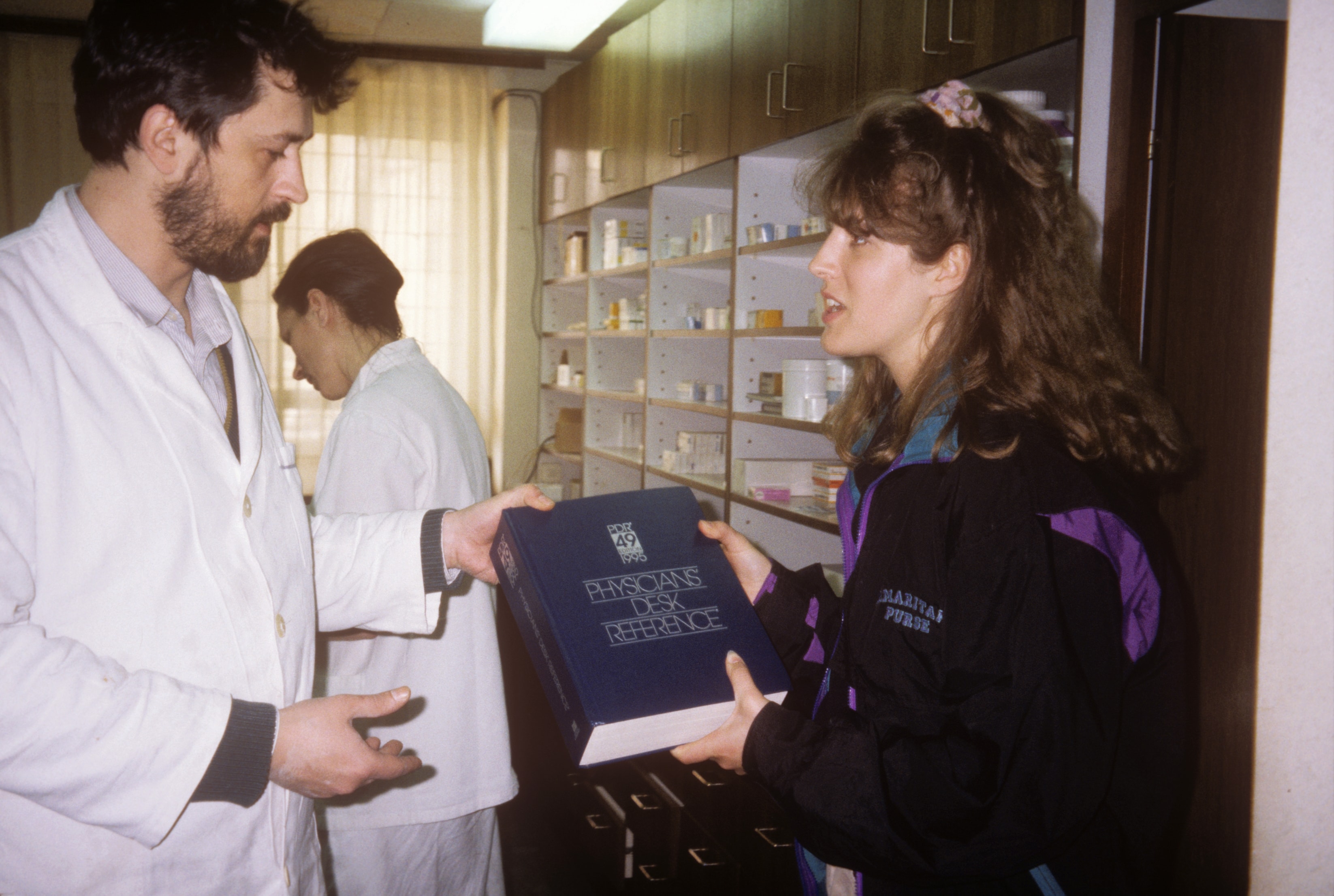 Dr. Susan Vitalis consulting with a doctor in a pharmacy in Bosnia