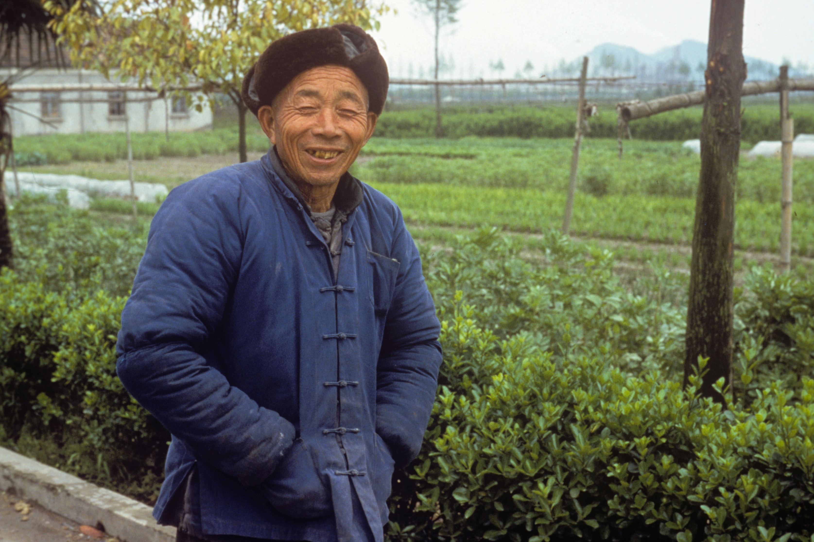 Farmer smiling in vegetable garden, China