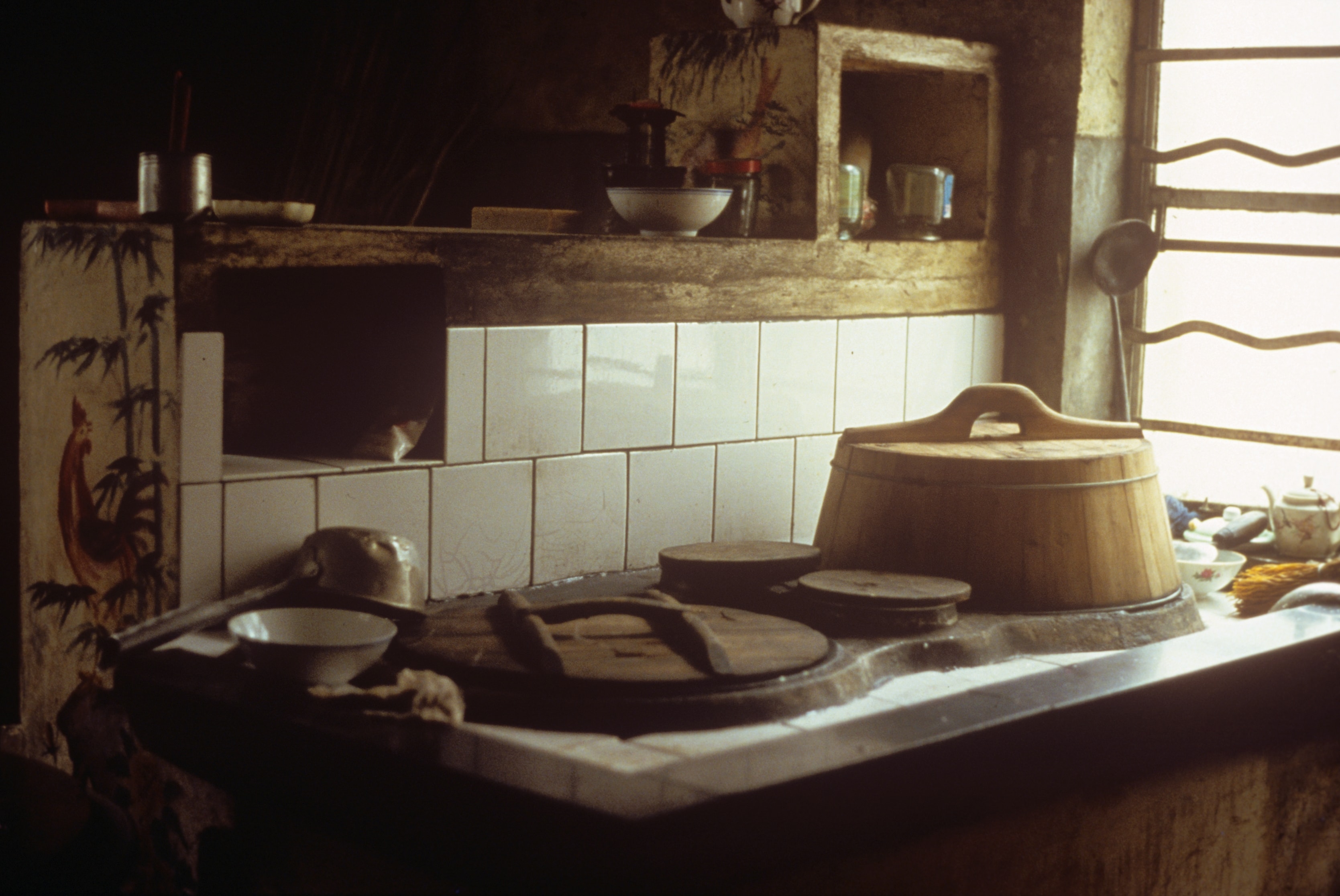 Traditional Chinese kitchen with wooden steamer and tiled stove