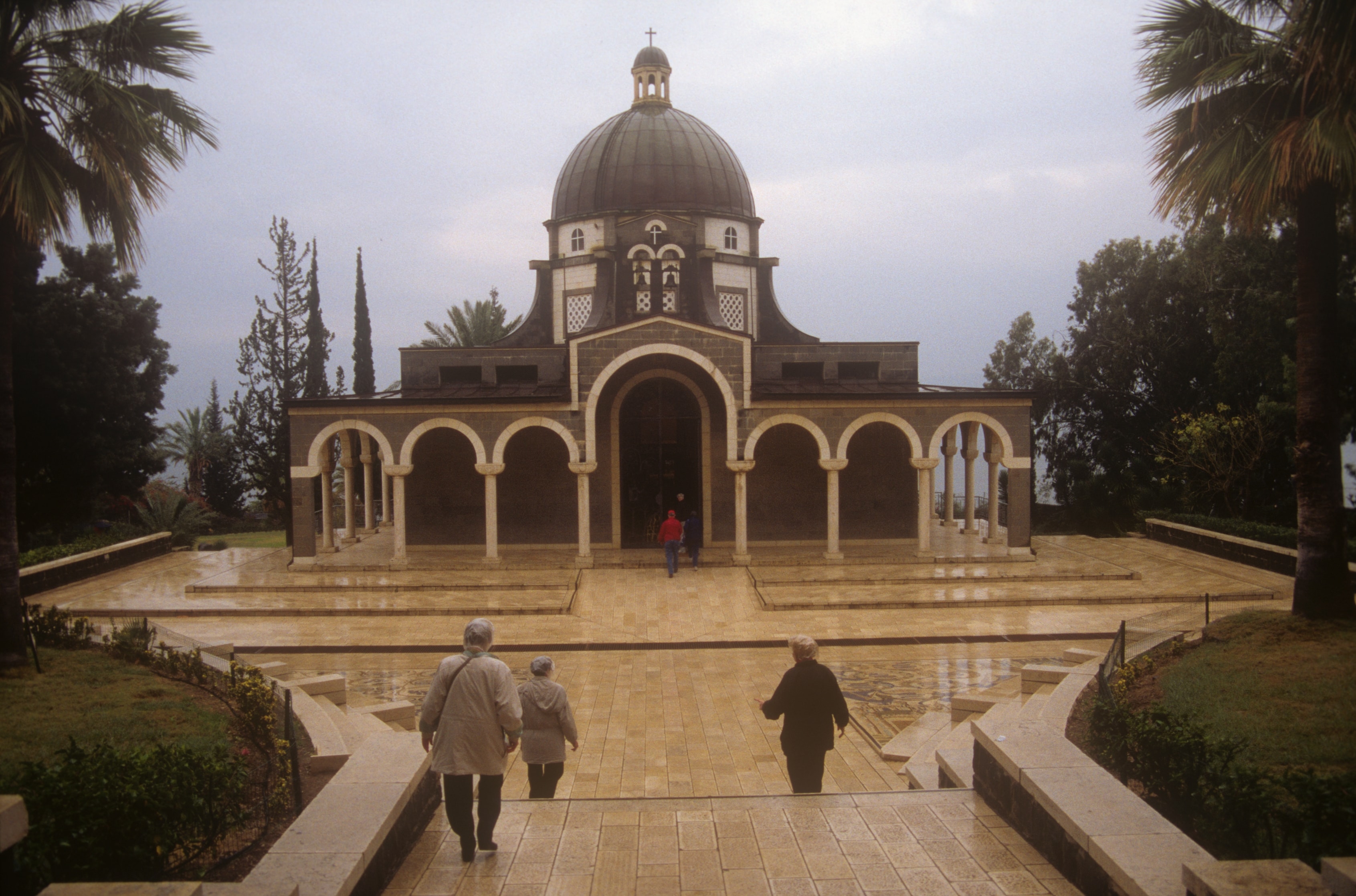 Visitors approaching the domed Church of the Beatitudes in the Holy Land