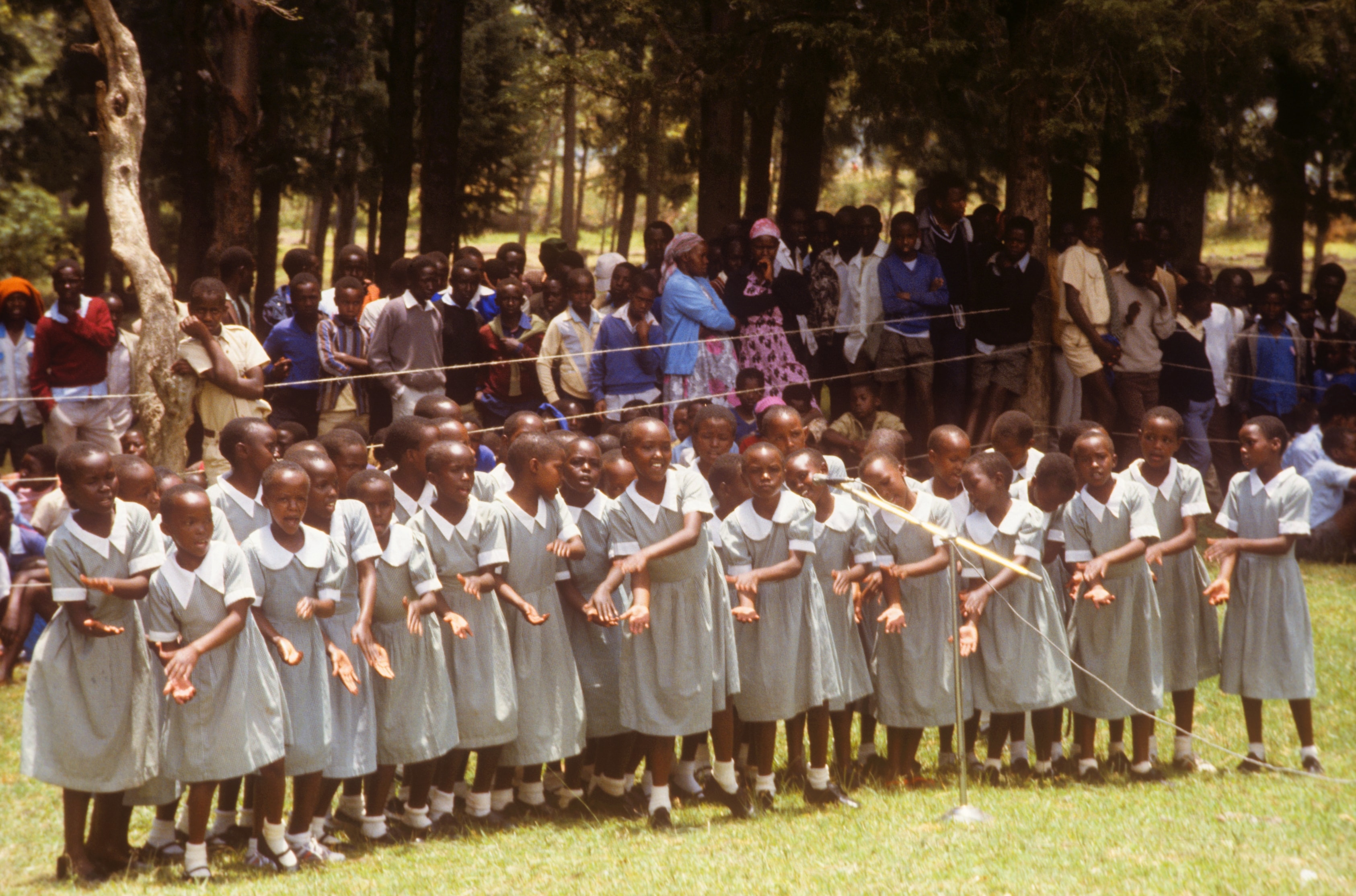 Schoolgirls in uniform performing at an outdoor event in Kenya