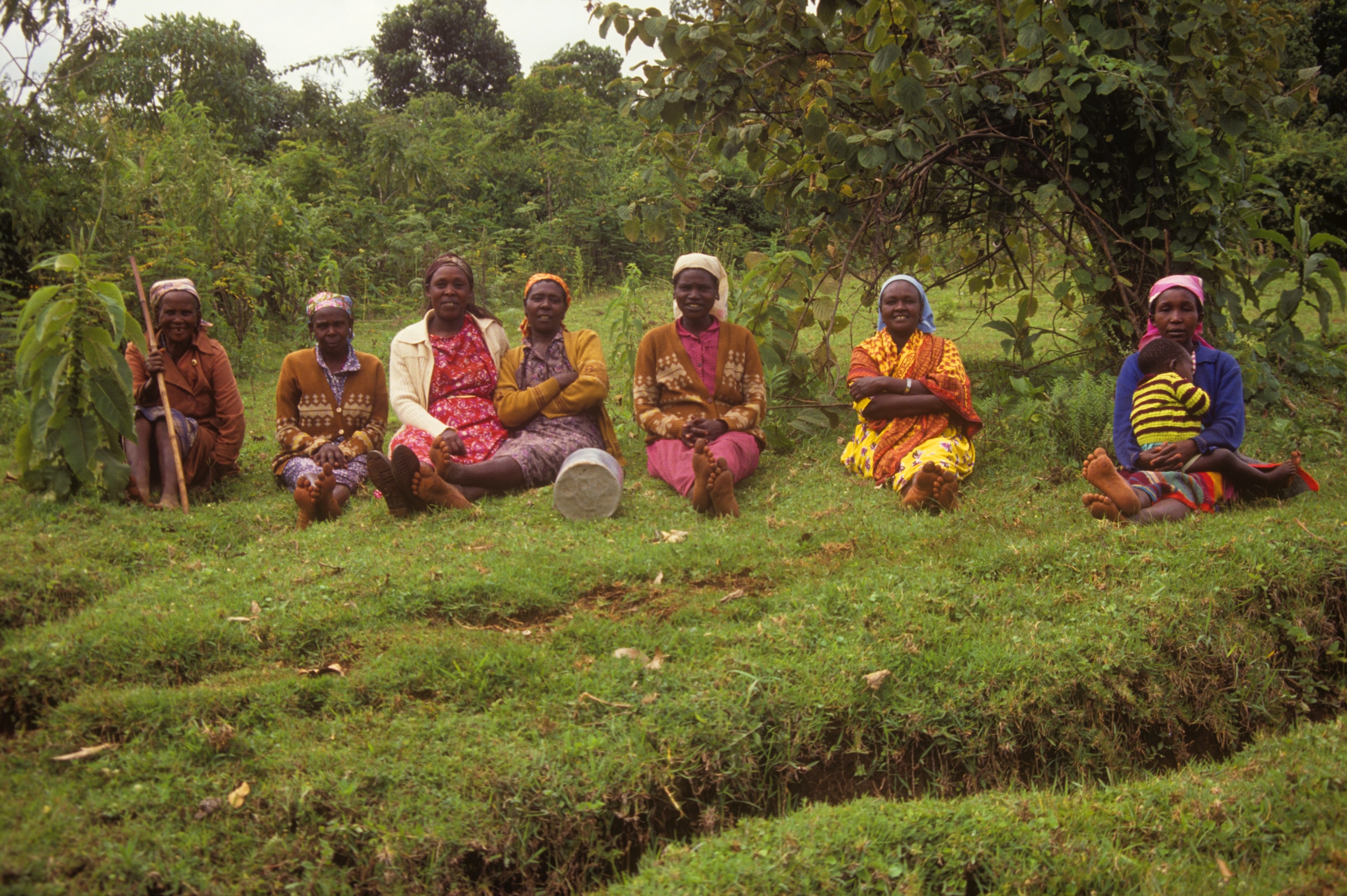 Women sitting together in a lush garden in Kenya