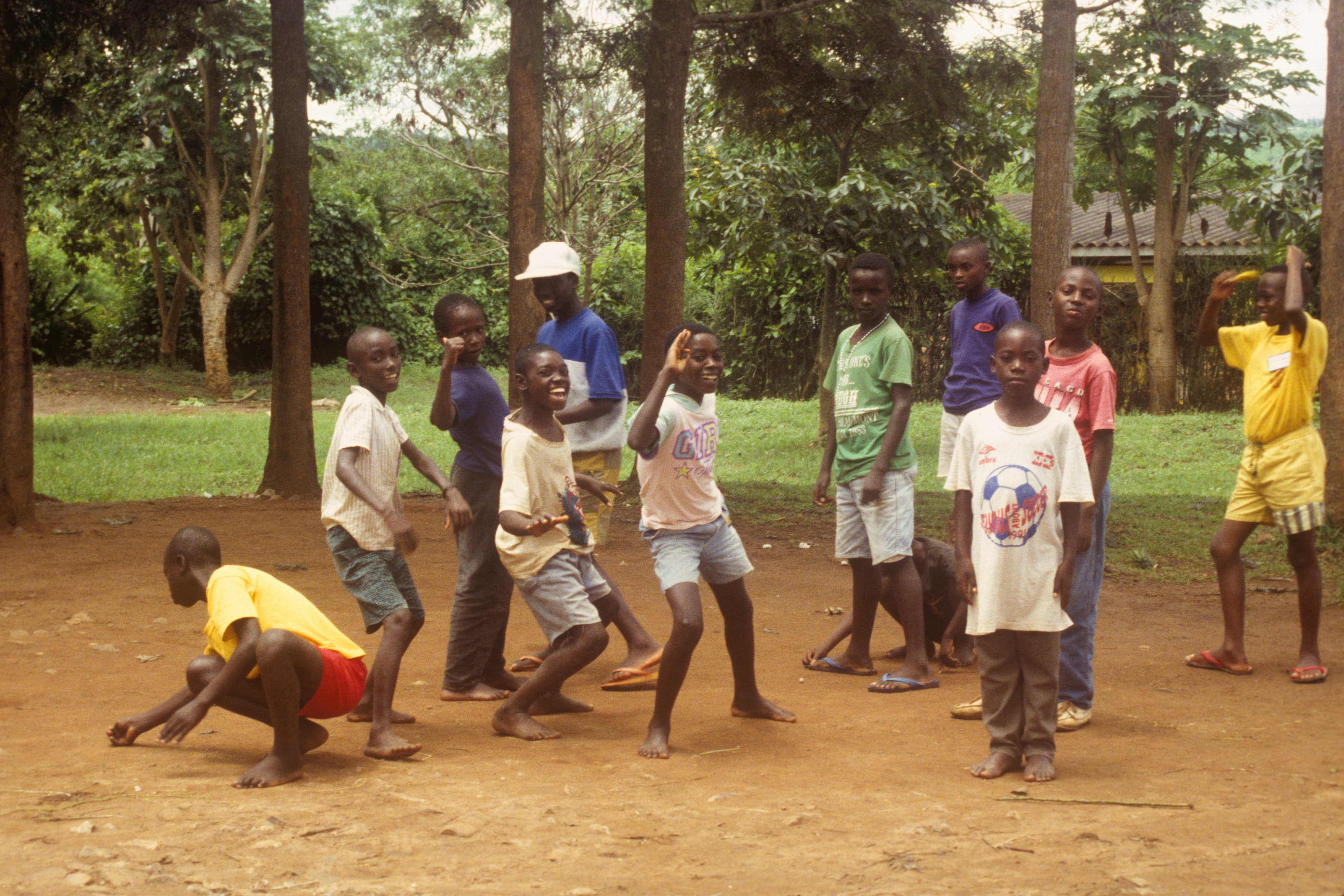 Group of children playing and dancing outdoors in Rwanda