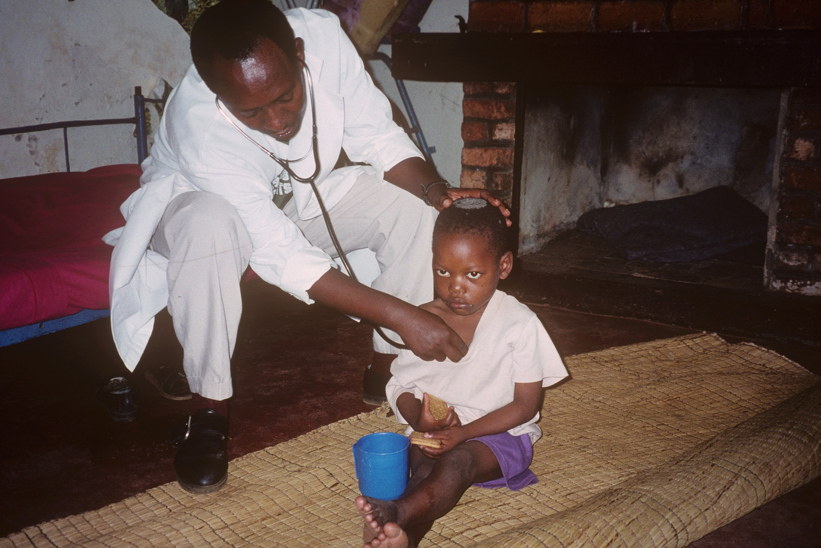 Doctor examining a young child with a stethoscope in Rwanda