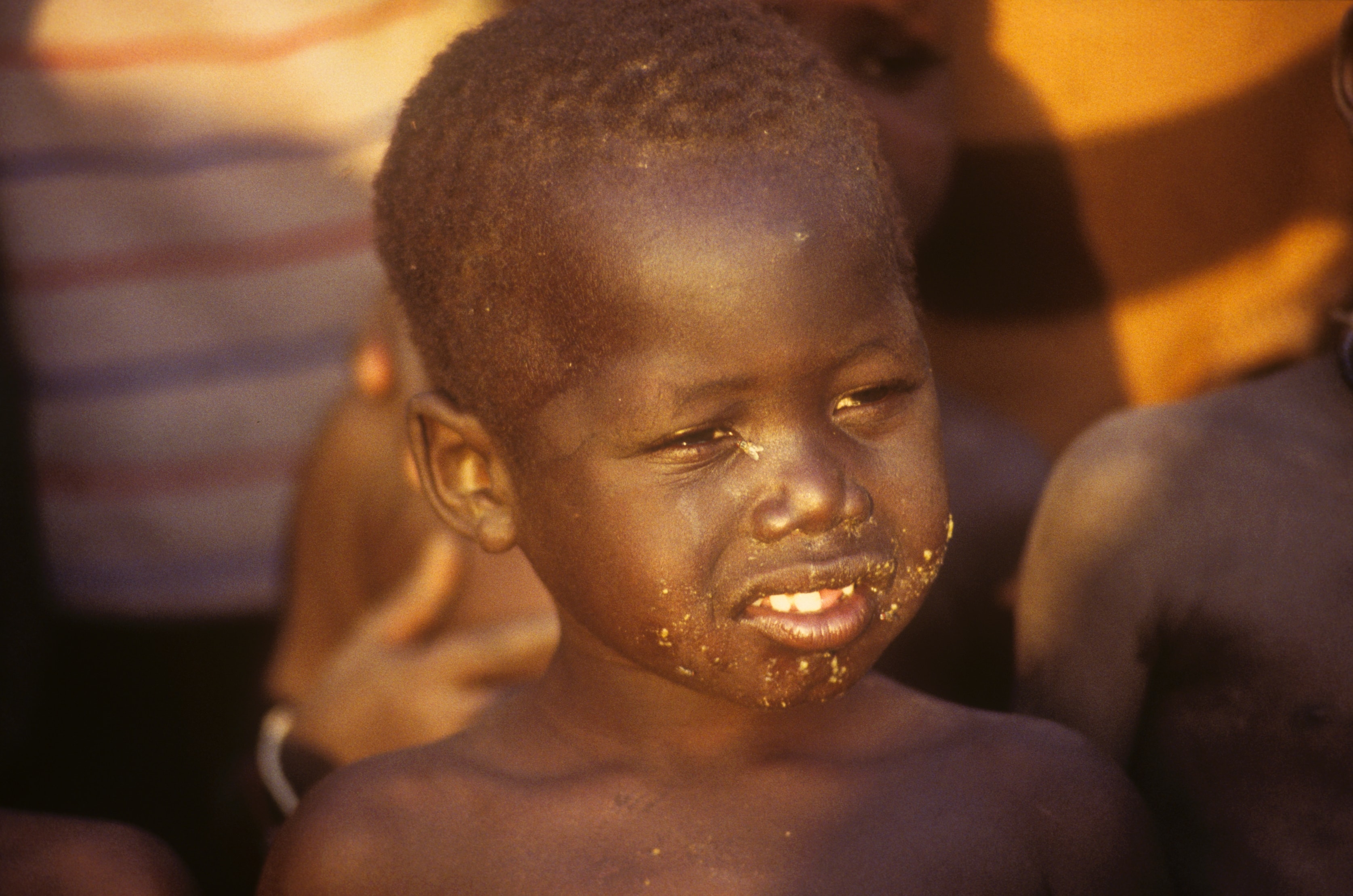 Close-up portrait of a young child in warm golden light in Sudan