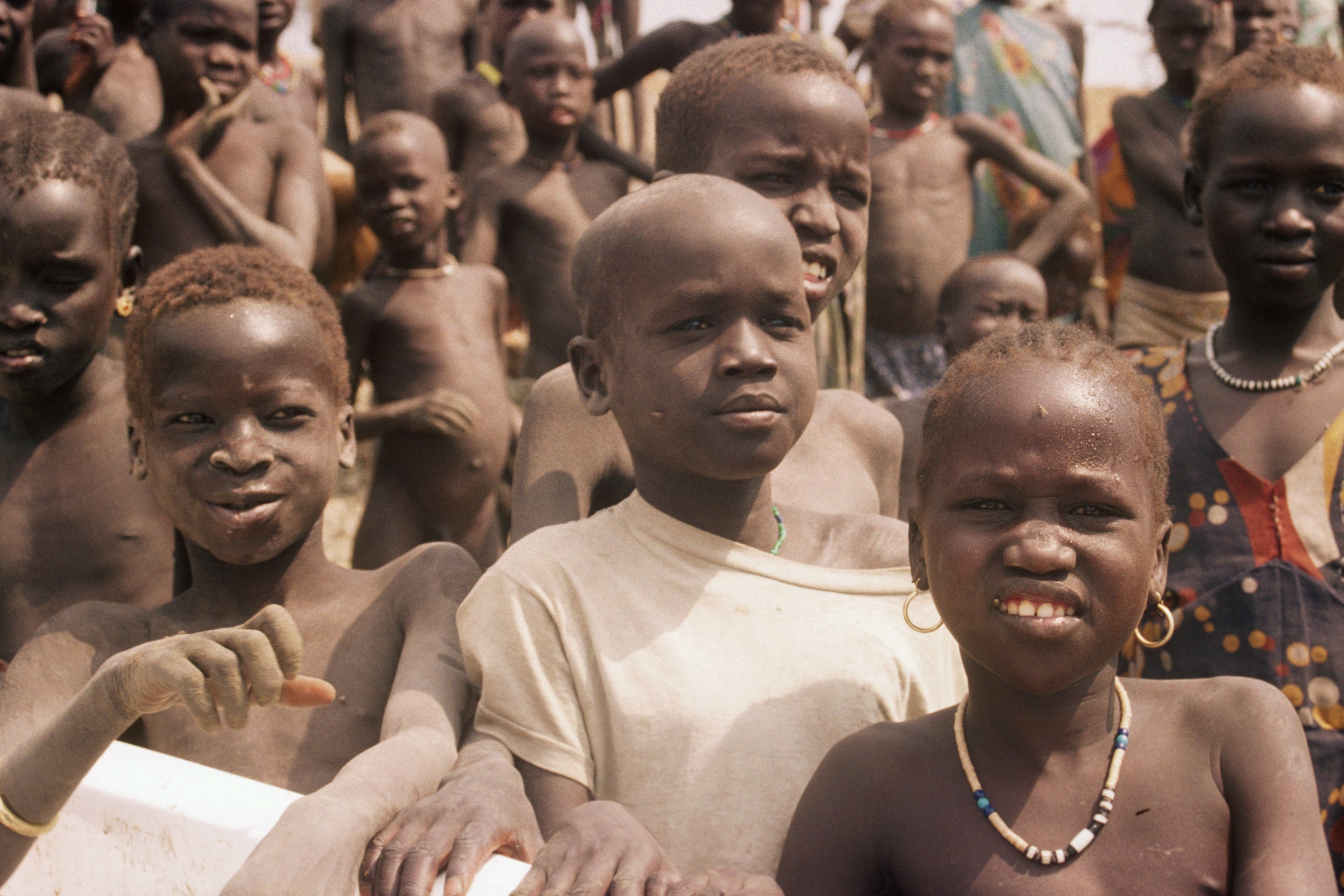 Group of young children looking at the camera in a Sudanese village