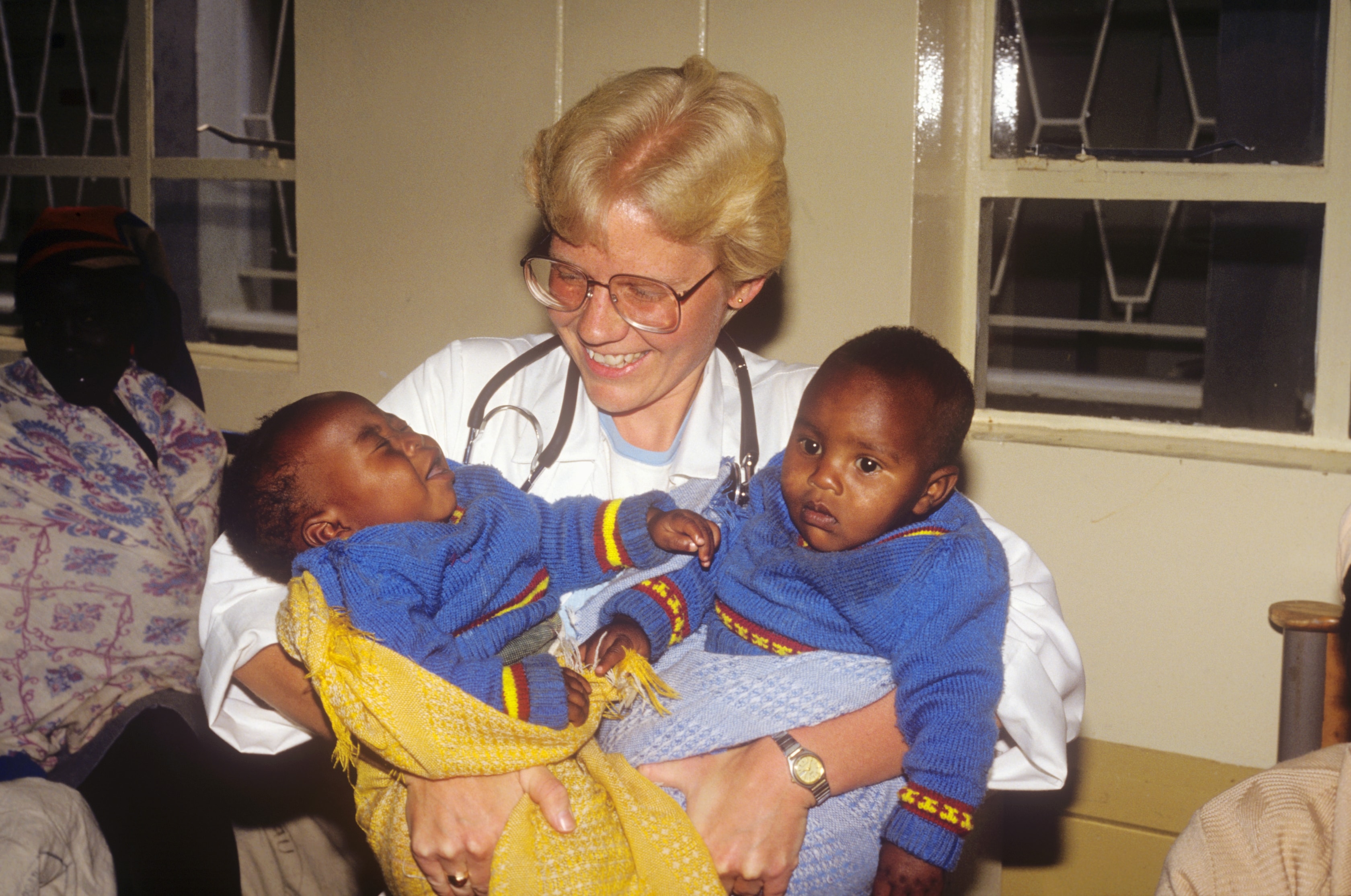 Dr. Susan Vitalis holding two babies in Kenya