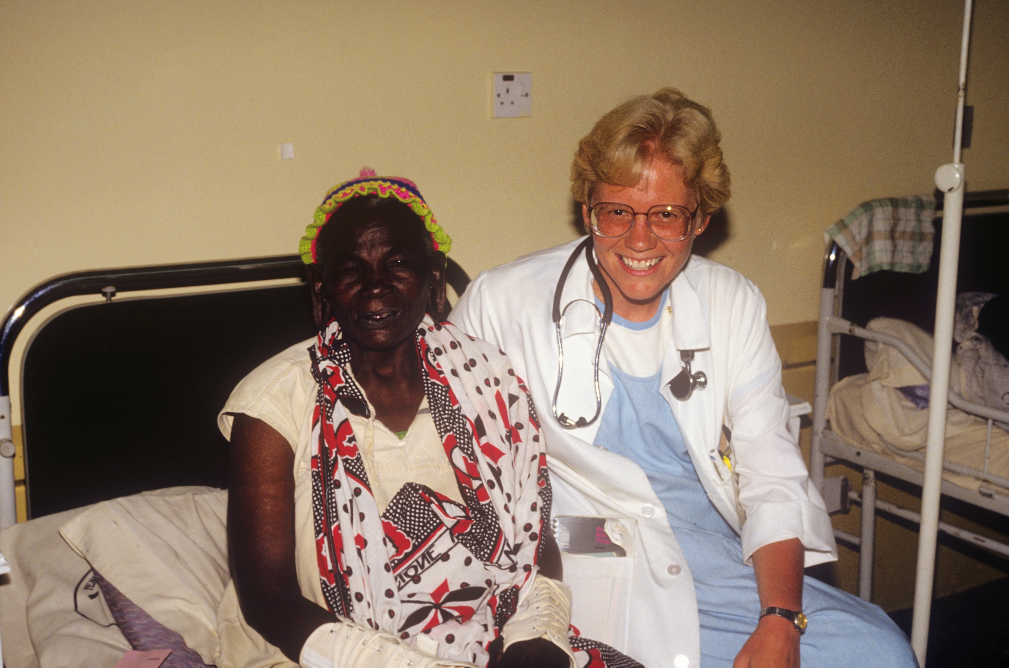 Dr. Susan Vitalis with a patient at bedside in Africa