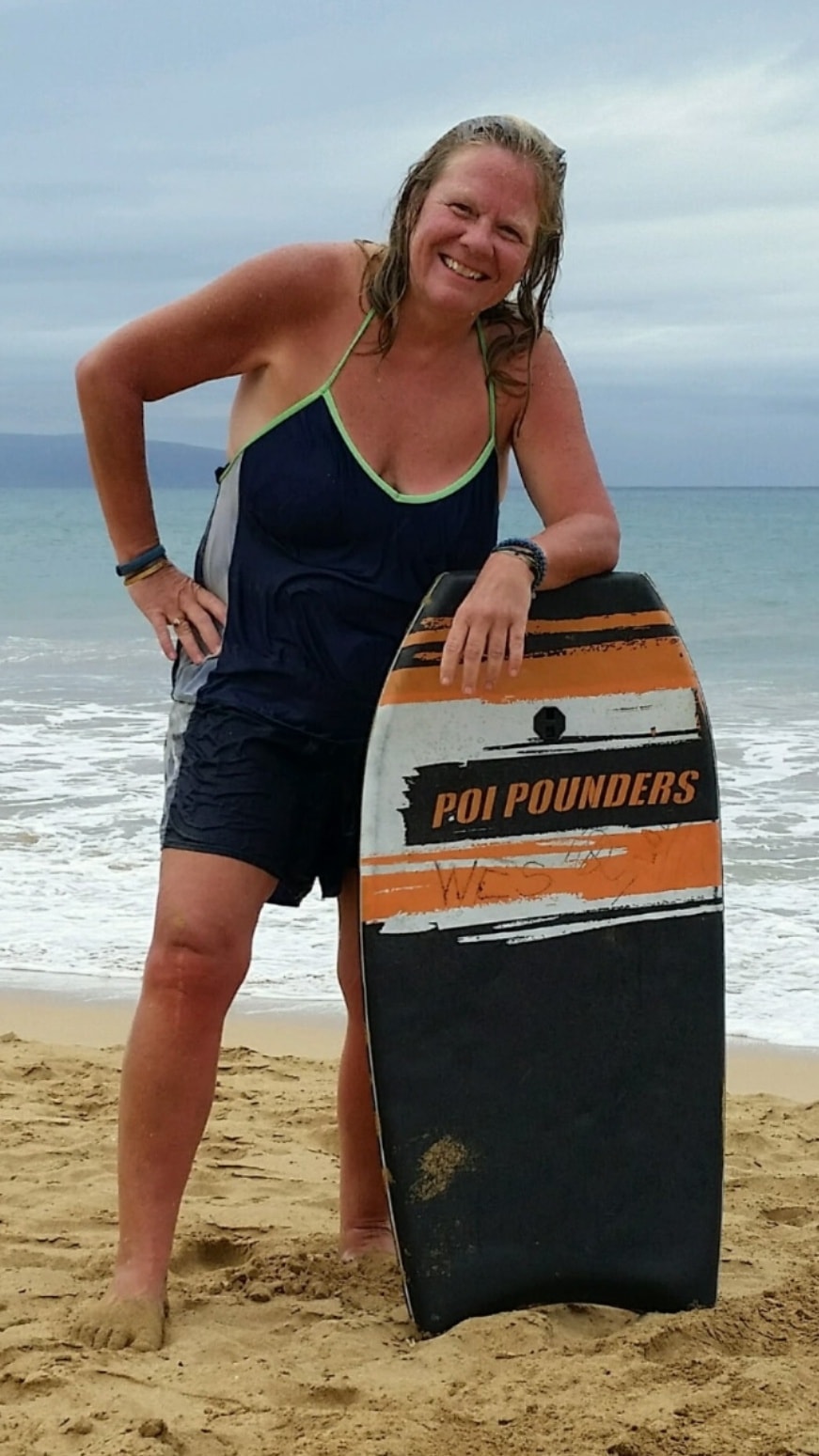 Susan Vitalis at the beach with a bodyboard